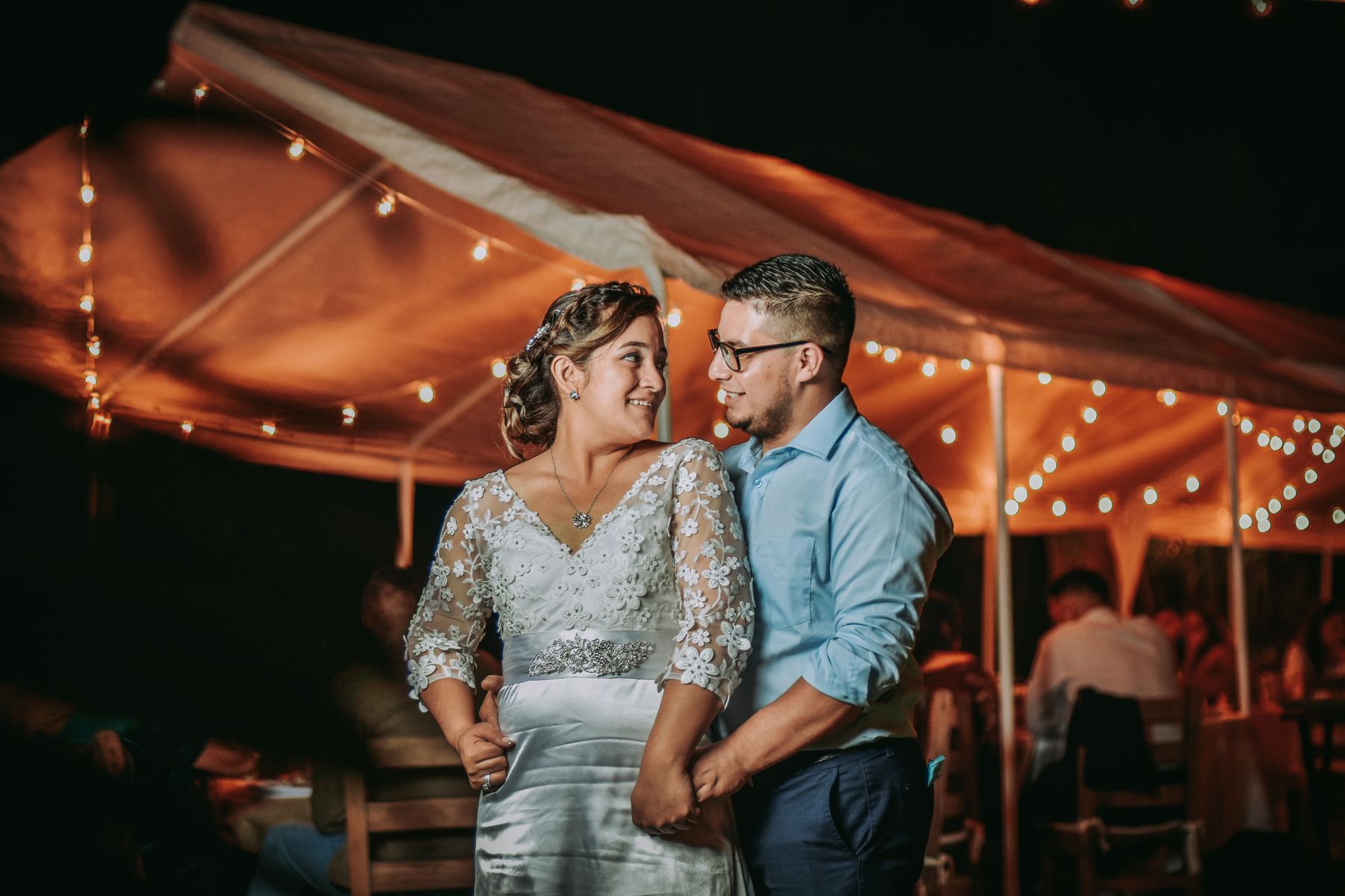 Couple dancing under string lights